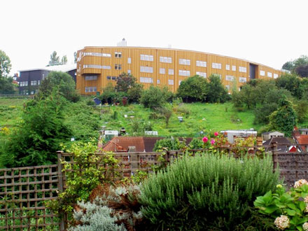 view of a school building with greenery behind it